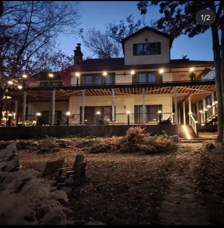 Multi-level deck with string lights at dusk