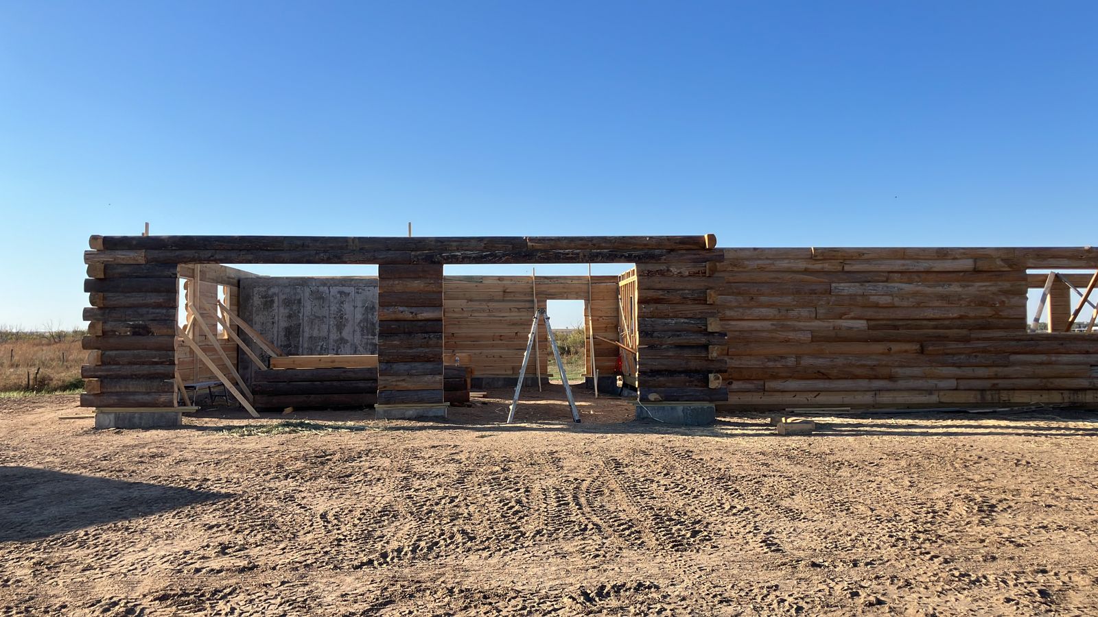 Log cabin walls on an open lot