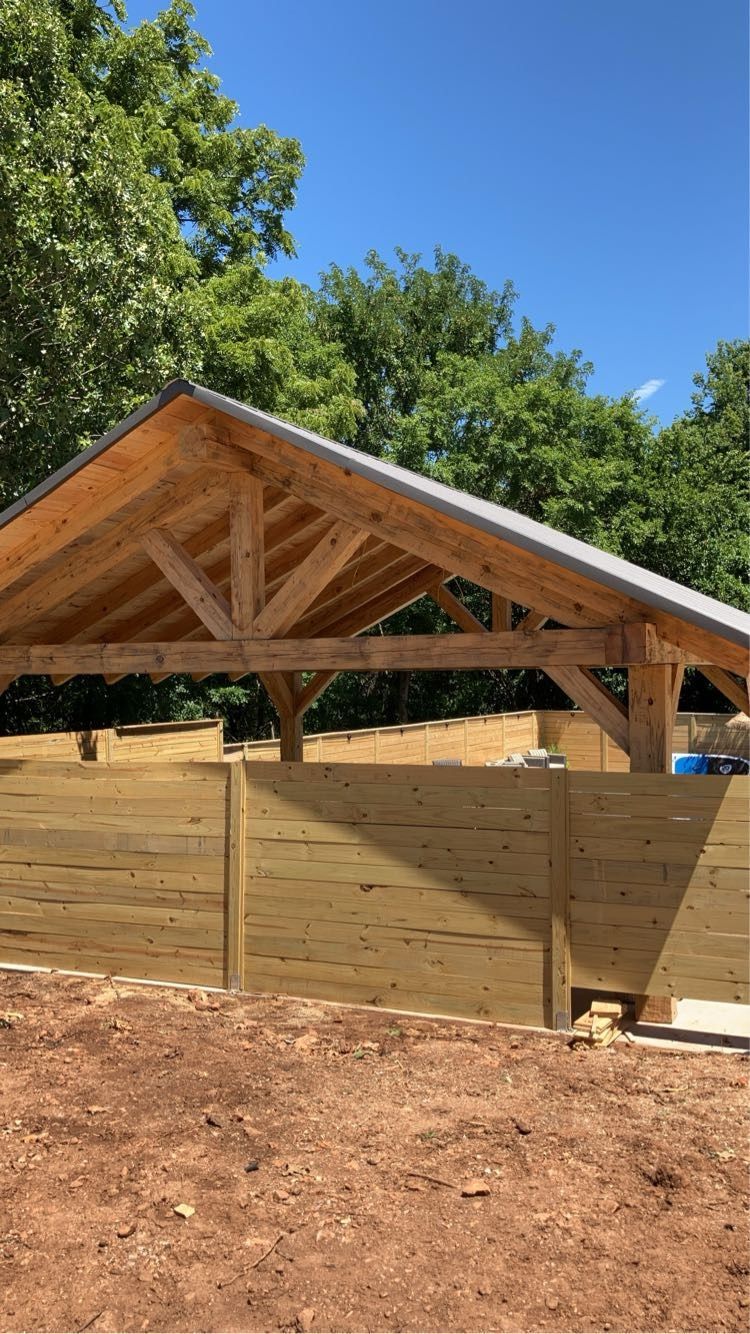 Timber pavilion with metal roof and privacy wall