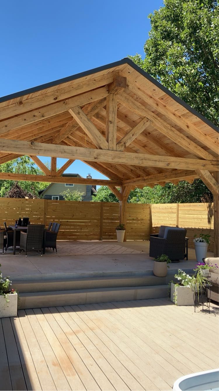 Finished timber frame pavilion over a backyard patio